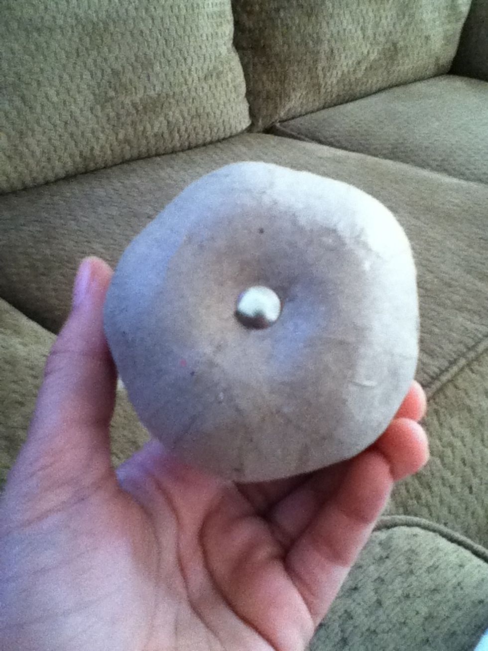 Start by putting one thumb tack in the center of the bottom. Gradually work your way up in rings around the fruit. Try to make it as even as possible.