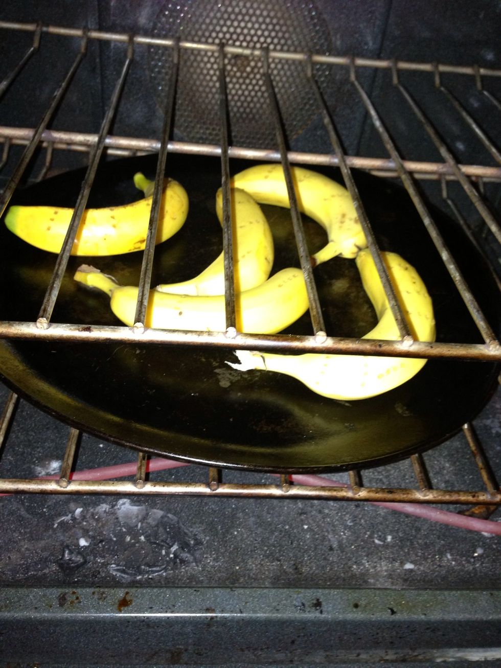 Start by putting your bananas on a cookie sheet. Use a fork to poke holes evenly throughout each banana. Bake at 350 degrees until banana peels turn black. About 20 min, maybe less. (: