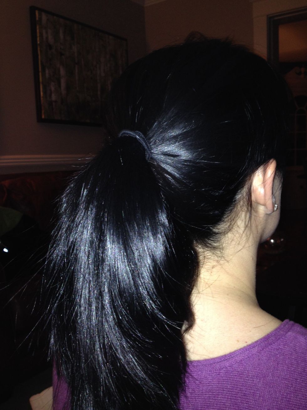 Start by putting your hair in a mid ponytail