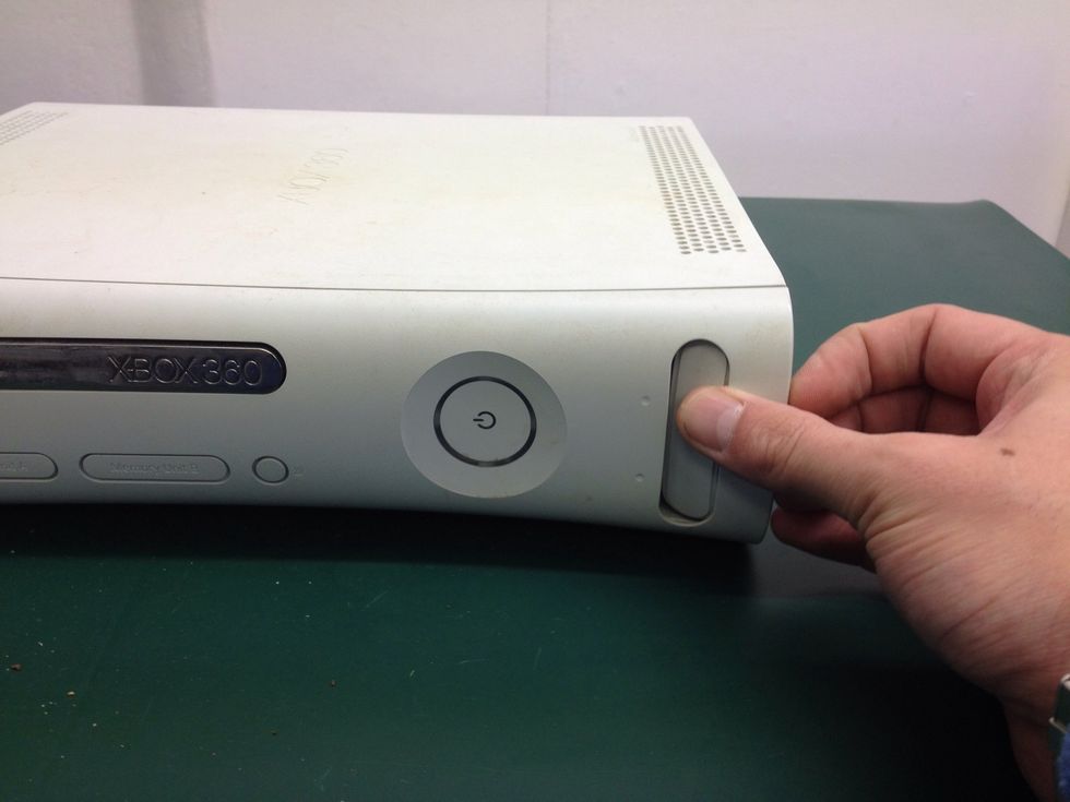 Start by removing the front bezel. Pull from the bottom (if vertical) or the right-hand side (if horizontal).