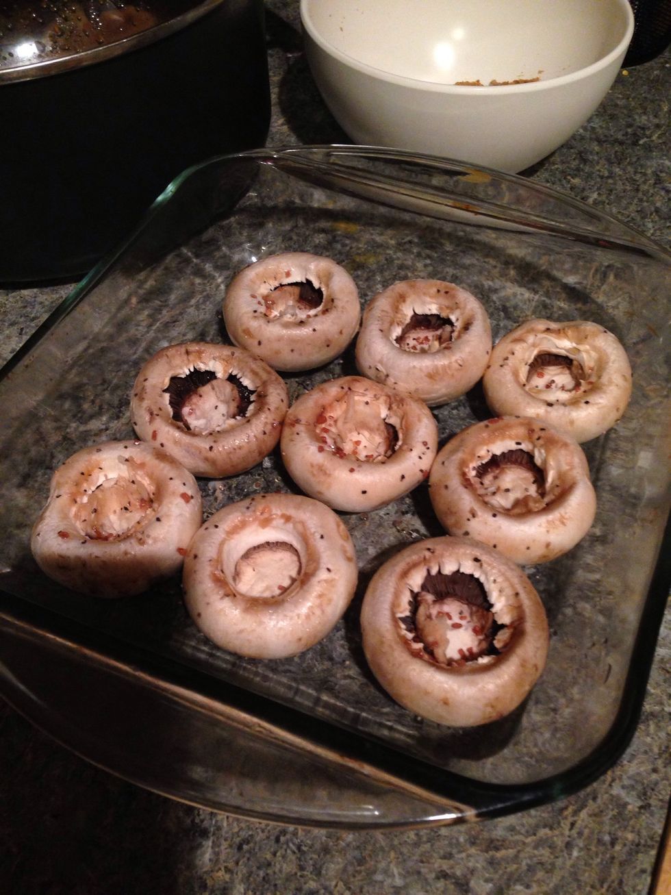 Start by removing the hulls of your mushrooms and placing up-side down in a prepared baking dish.