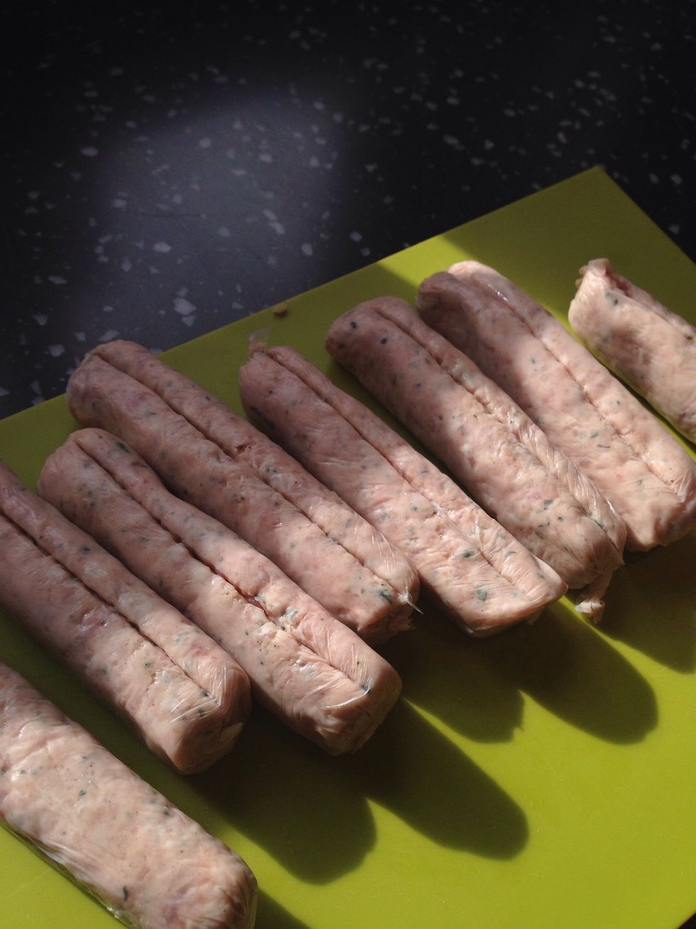 Start by removing the skins from the sausages. Just make a slit down each one and the skin should peel off easily. Put the sausage meat in a large bowl