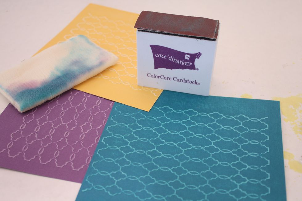 Start by running your 6x6 paper through your embossing folder. Then lightly sand embossing with your sanding tool and wipe after each color with the included cloth