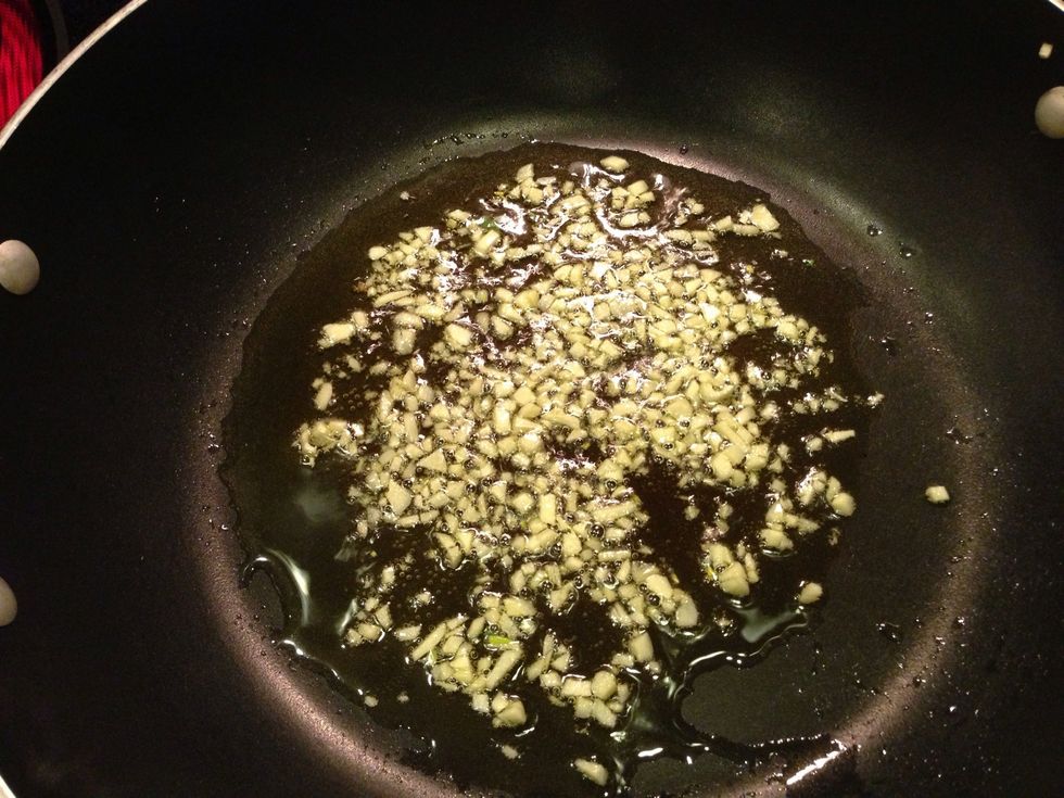Start by saut\u00e9ing the garlic in the olive oil over medium-low heat. Watch carefully to make sure it doesn't burn!