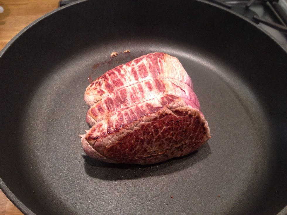 Start by searing your joint of beef in a hot pan. This means cooking for a few seconds on each side so it goes broken and seals in the juices. Pre-heat your oven to the top temperature