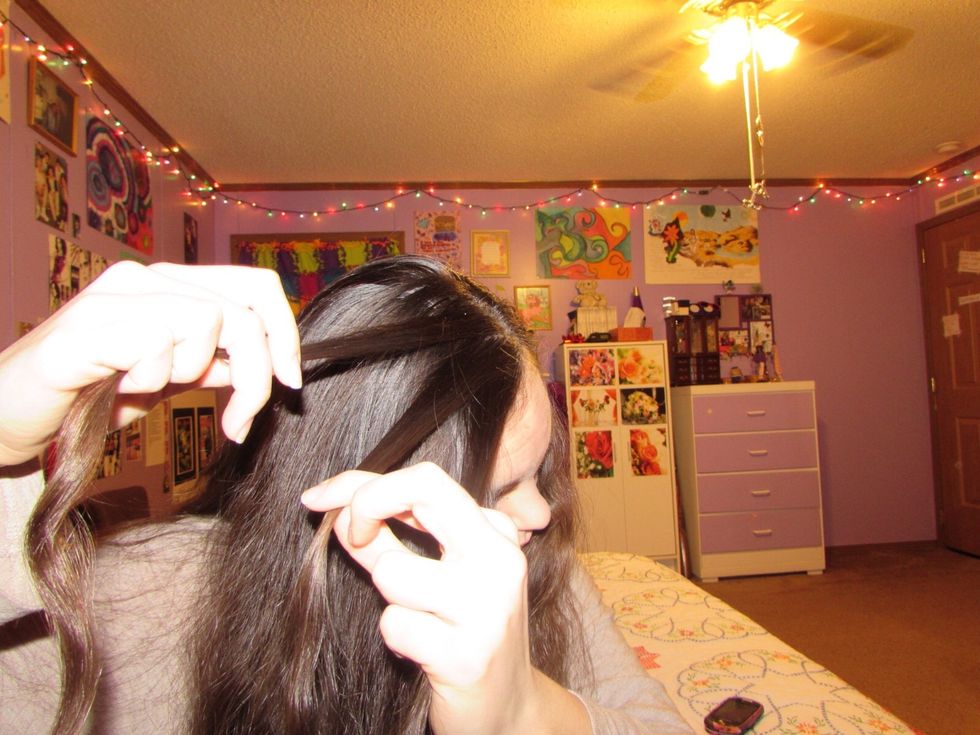 Start by sectioning off three strands of equally proportioned hair.