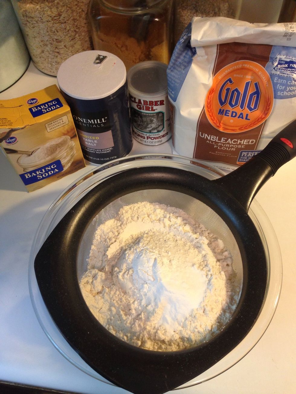 Start by sifting together your flour, salt, baking powder, and baking soda. From my other guides, you know I love my big mesh strainer. Here is another use for it. Put everything in and sift together.
