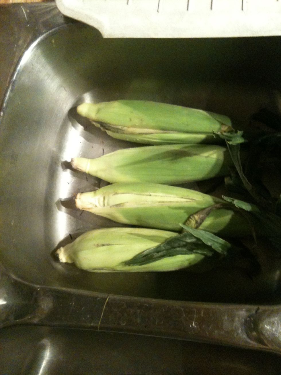 Start by soaking the corn with cold water in the sink or bucket. I let it soak for about 1/2-1 hour.