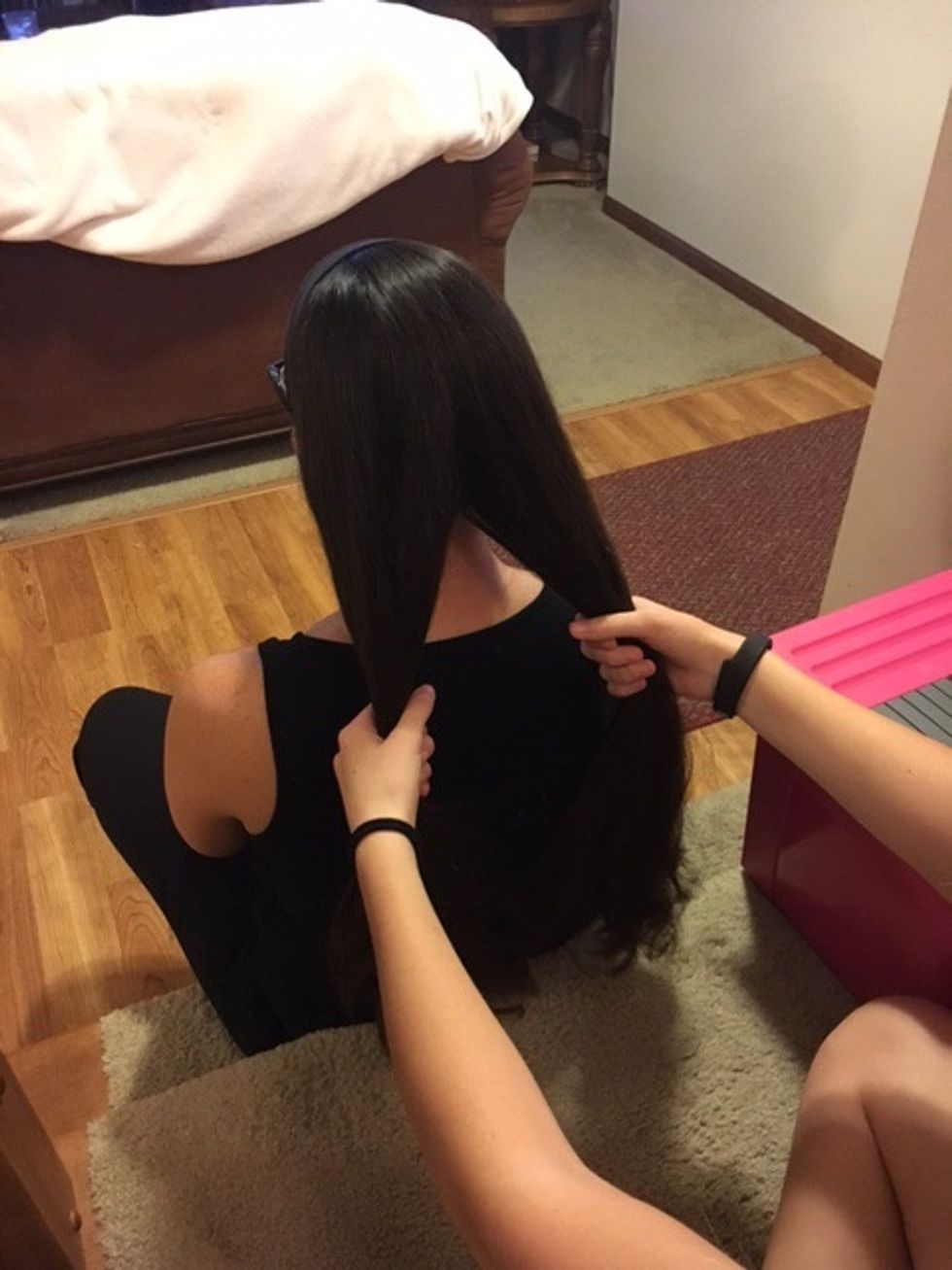 Start by splitting the brushed hair in half.