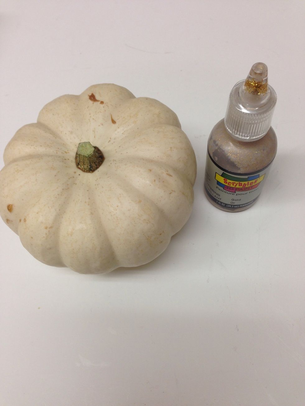 Start by squeezing glitter glue onto your pumpkin. You can use a little or a lot.