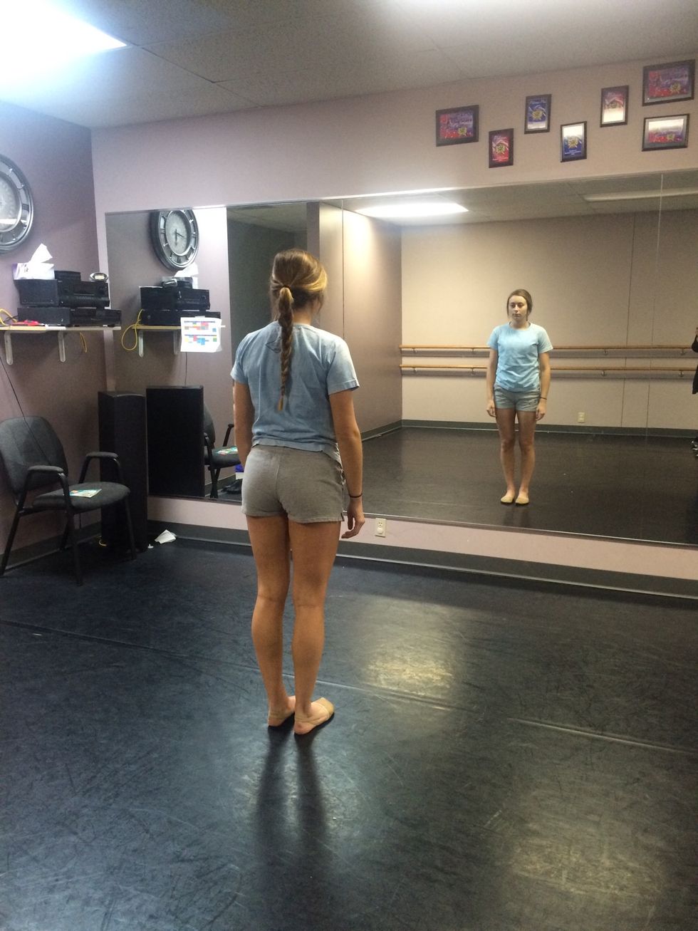 Start by standing straight up, feet shoulder-width apart and hands by your side. To be most successful, practice on a smooth surface clear of obstacles with dance shoes or socks to turn in.