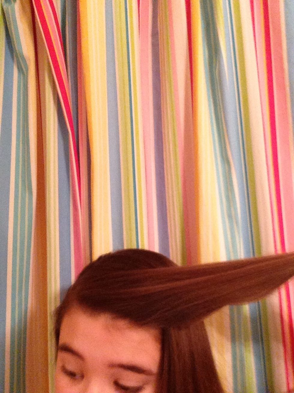 Start by taking a small section of hair from your head
