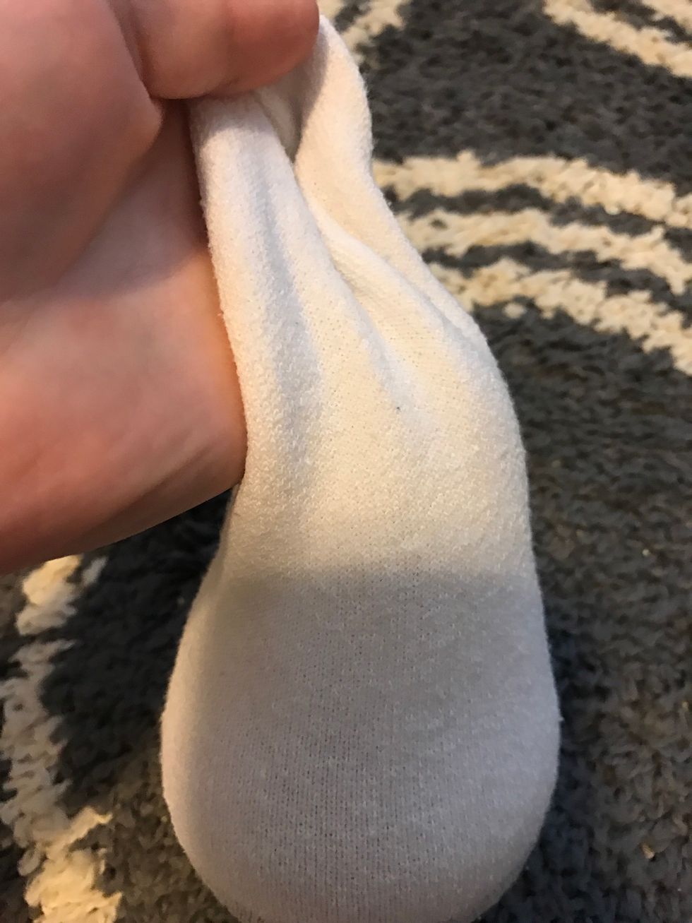 Start by taking a white sock and cutting off the top, fill it with rice