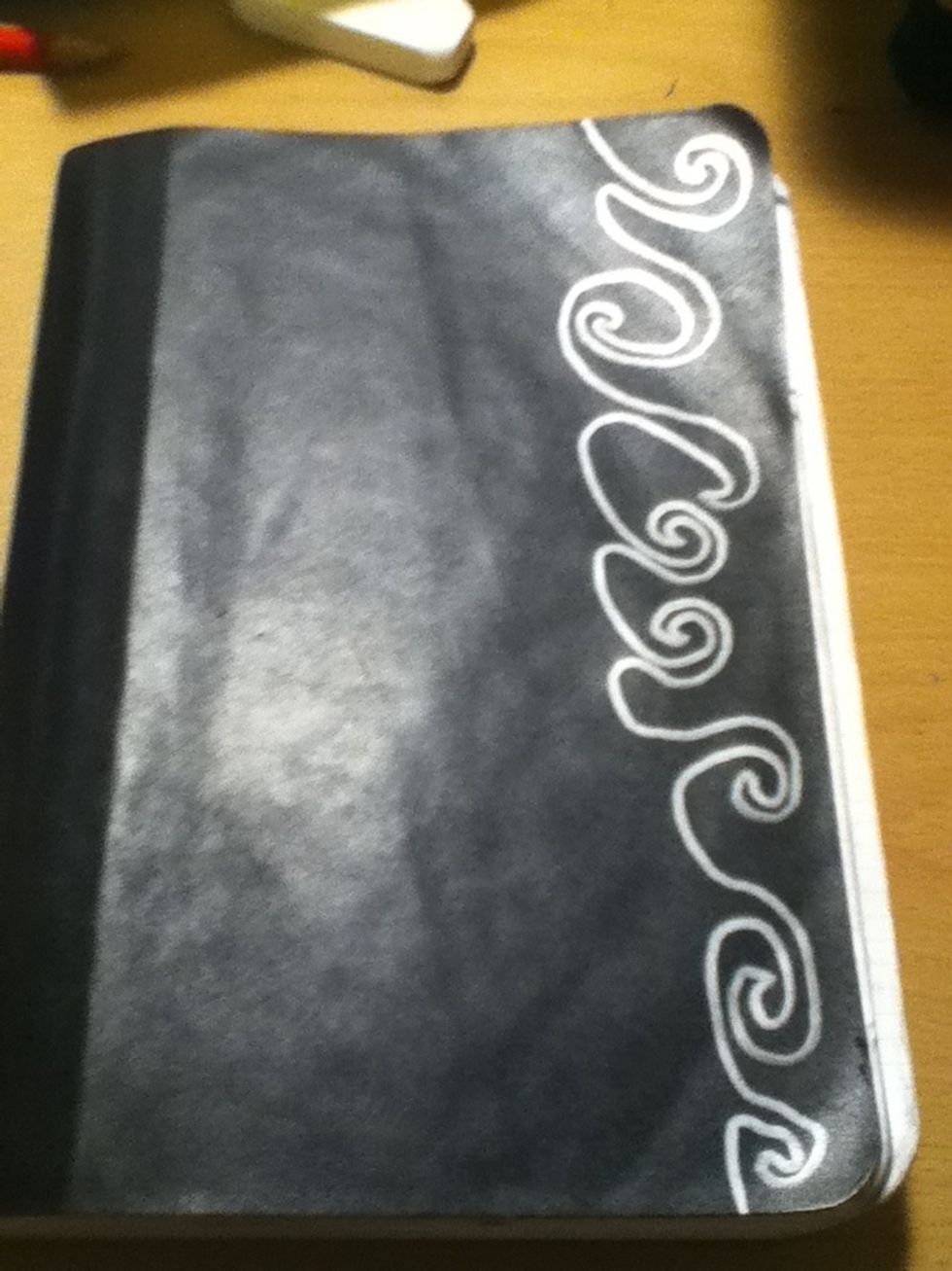 Start by tracing patterns or designs on the cover with sharpie. You can leave them as they are, or you can cut them out.