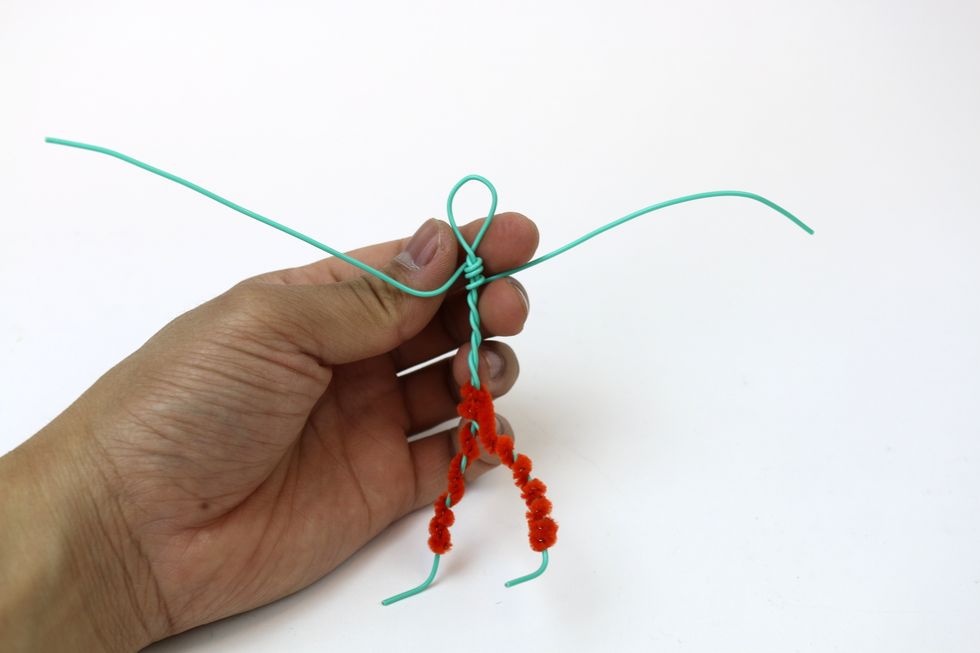 Start by twisting one end of the wire around the figure. Keep twisting the arm until it's length fits the proportion of your figure. repeat for the other arm.