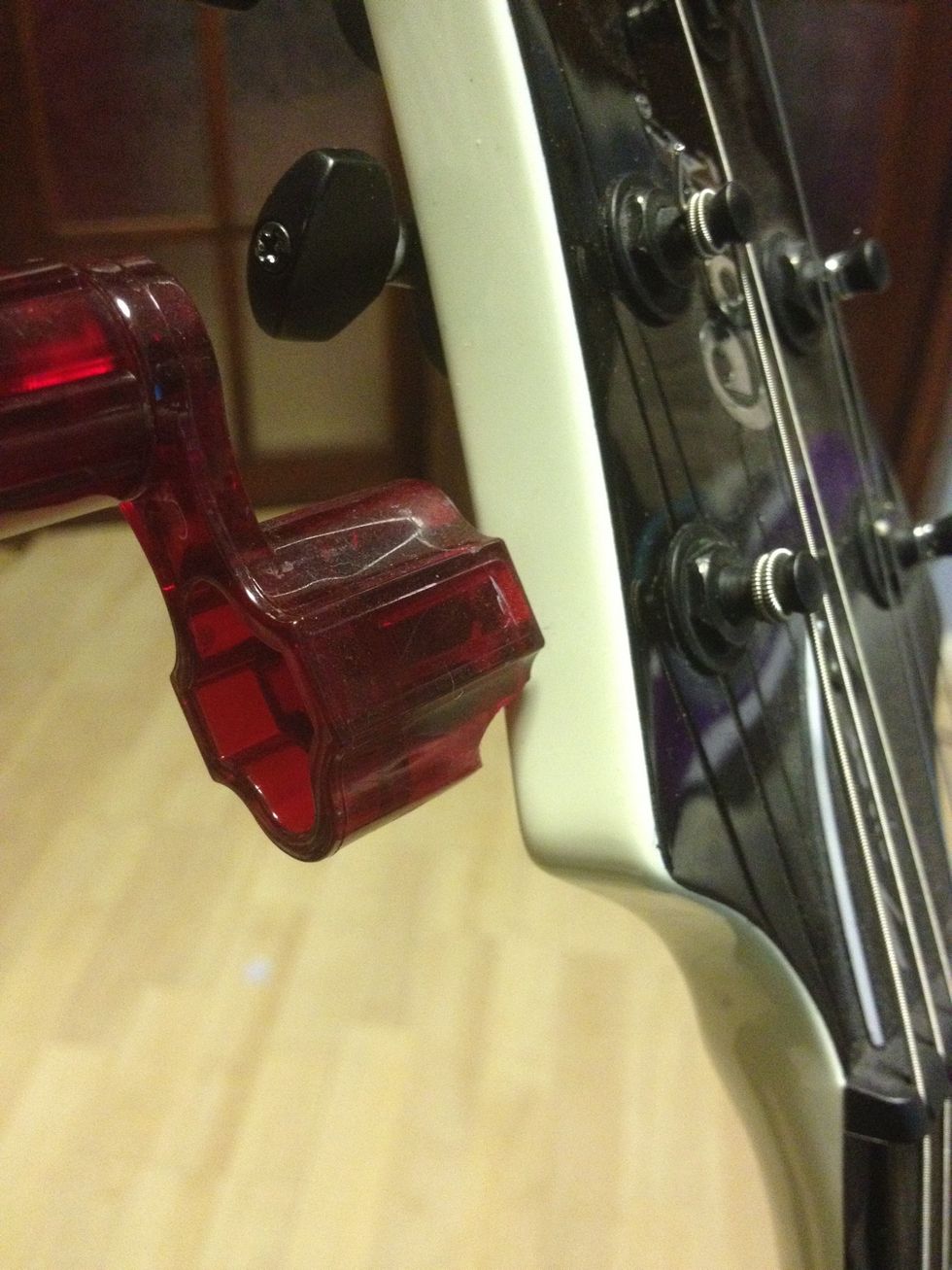 Start by unwinding all of the strings that are currently in your guitar. Remember the ends are sharp so watch your fingers