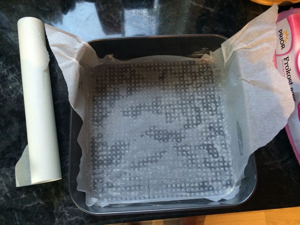 Start by warming your oven to 200\u00b0C. Take your baking tray and grease it with a little bit of butter, then place your baking paper inside your tray and grease it as well.