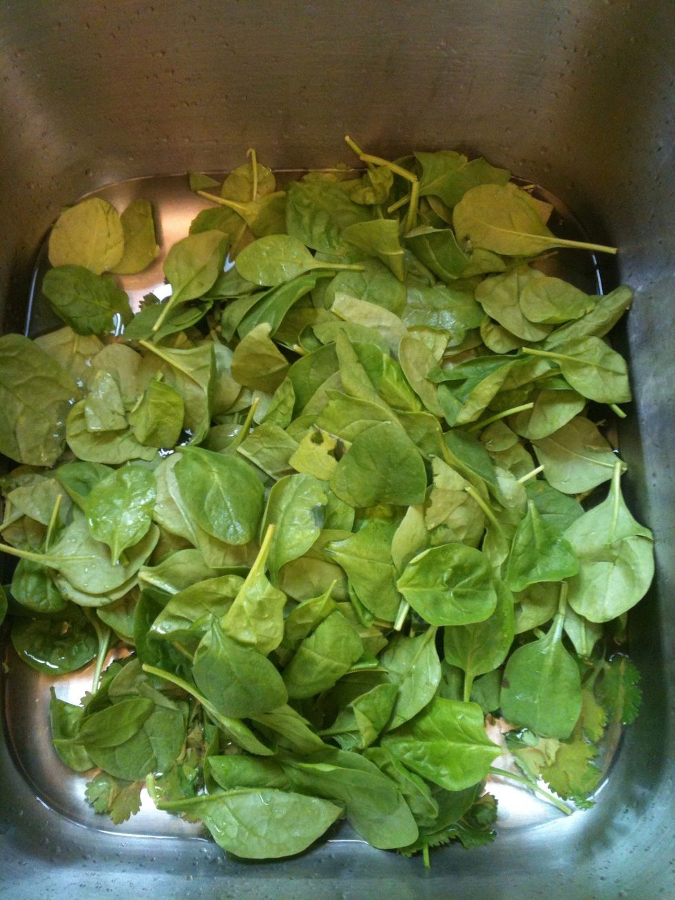Start by washing all of your veggies and fruits. I then fill the sink half way with water, and as I chop my leafy greens I toss them I the sink until they are needed.