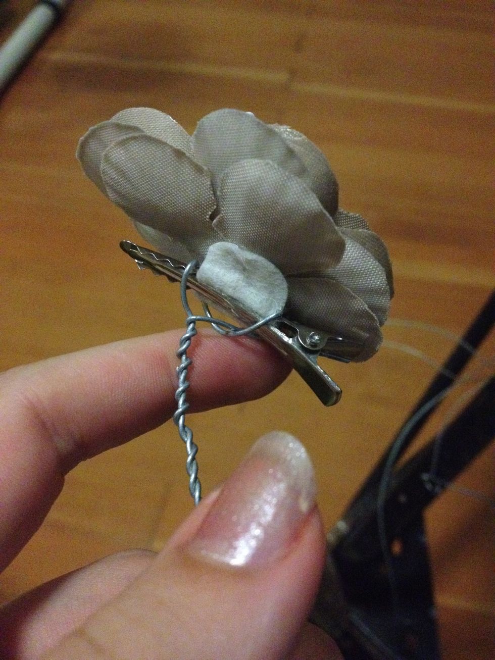 Start by wrapping your wire around the back of the broach in the most secure way .