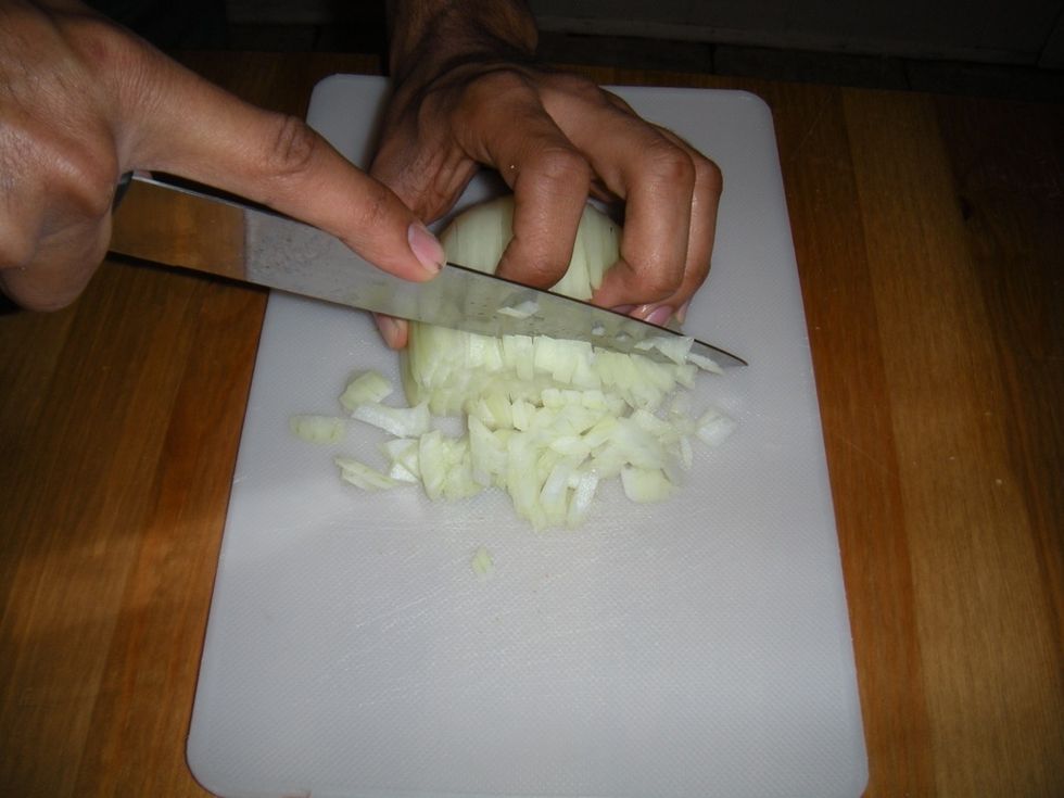 Start chopping the onion perpendicular to your previous cuts. Chop as close to the root as possible. Space your cuts depending on how finely chop the onion should be.