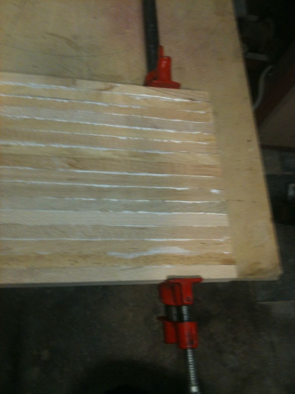 Start clamping the wood together. Any glue that squeezes out can be wiped away with a damp cloth.