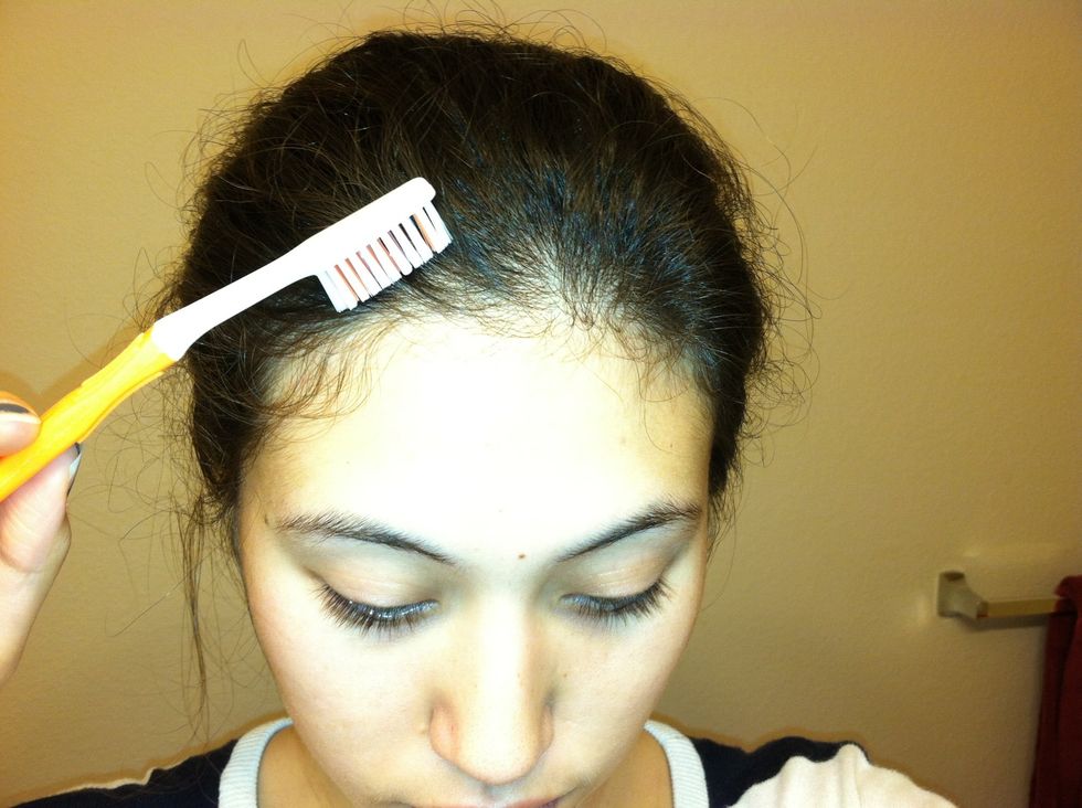 Start combing the hairs back using your hairspray covered toothbrush until most of the hairs stay back. If you feel like you need more hairspray, spray an additional amount to your toothbrush.