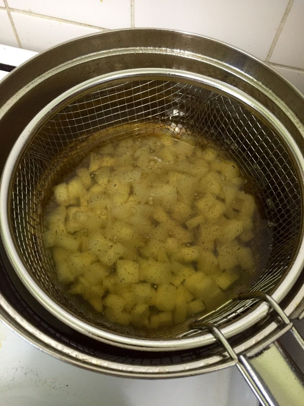 Start cooking the cubes in the oil. You can add salt to the raw potatoes but I tend to put it with the eggs