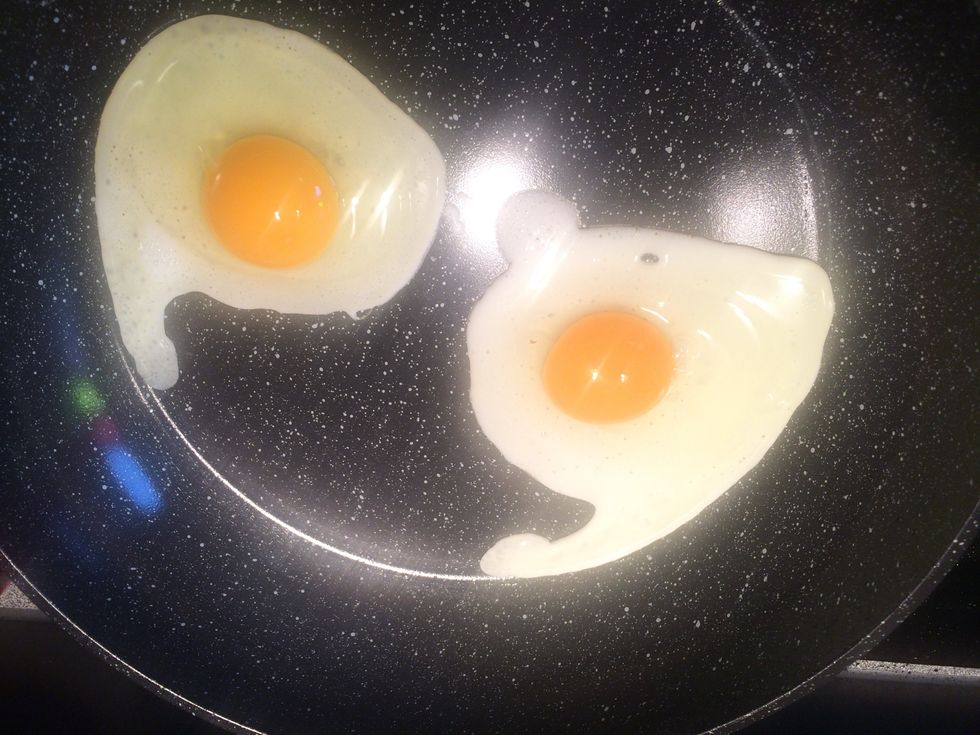 Start cooking the eggs sunny side up.