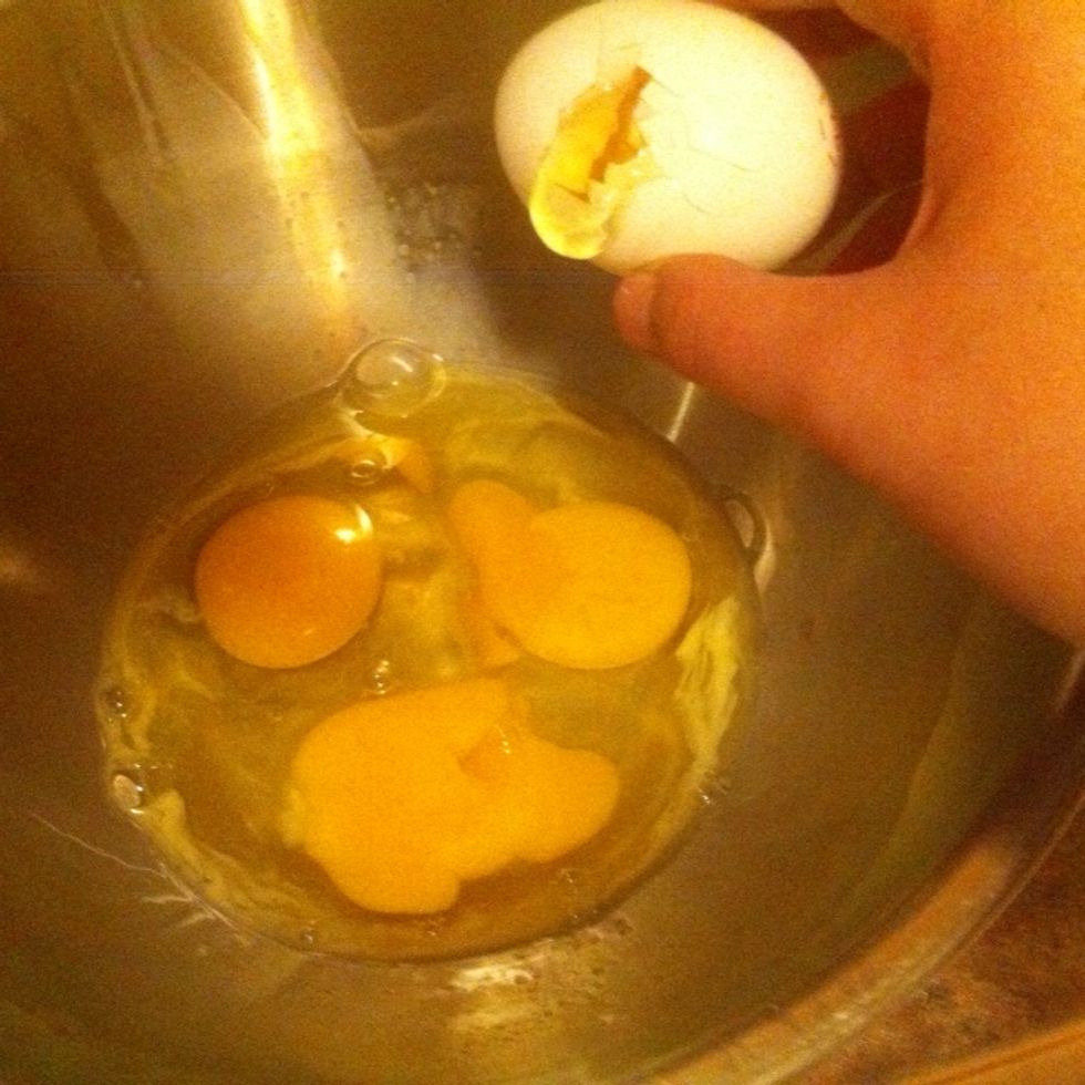 Start cracking the eggs into the large bowl.