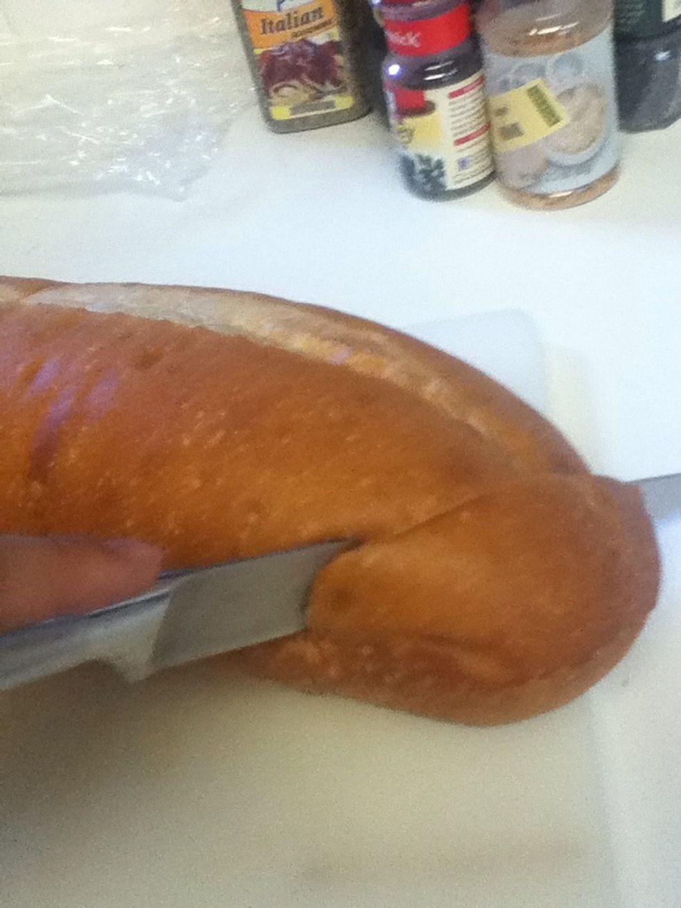 Start cutting the bread like you would garlic bread. DON'T cut all the way through and be careful, you don't want to smush the bread when you try to hold it.