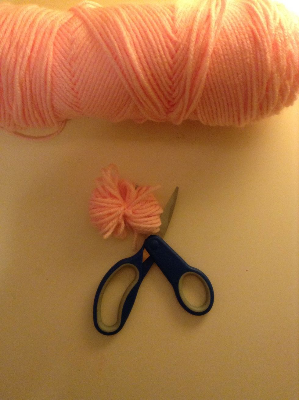 Start cutting the loops if yarn, be careful not to cut the yarn you tied to keep it together or else it will all come apart