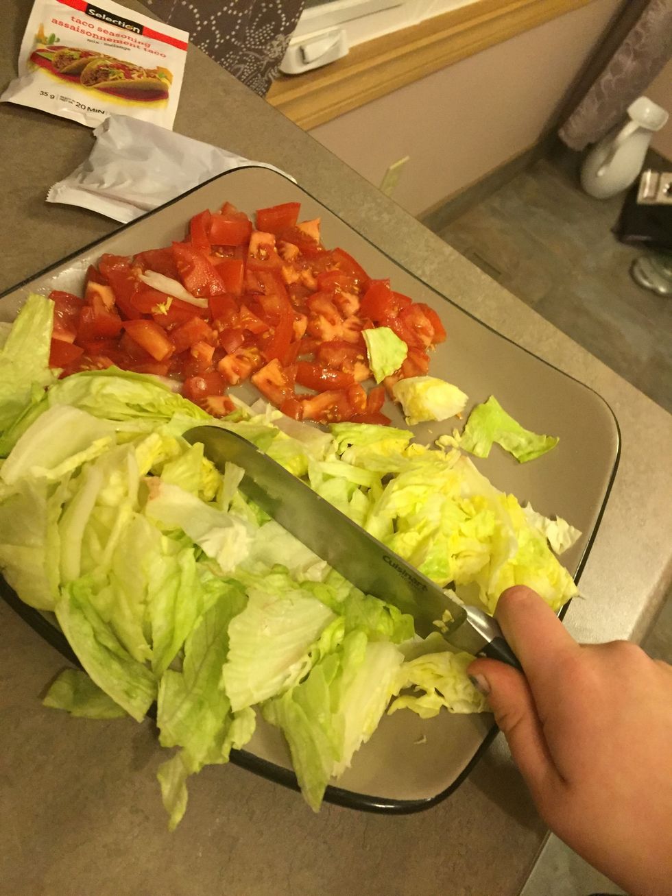 Start cutting up the tomatoes and lettuce.