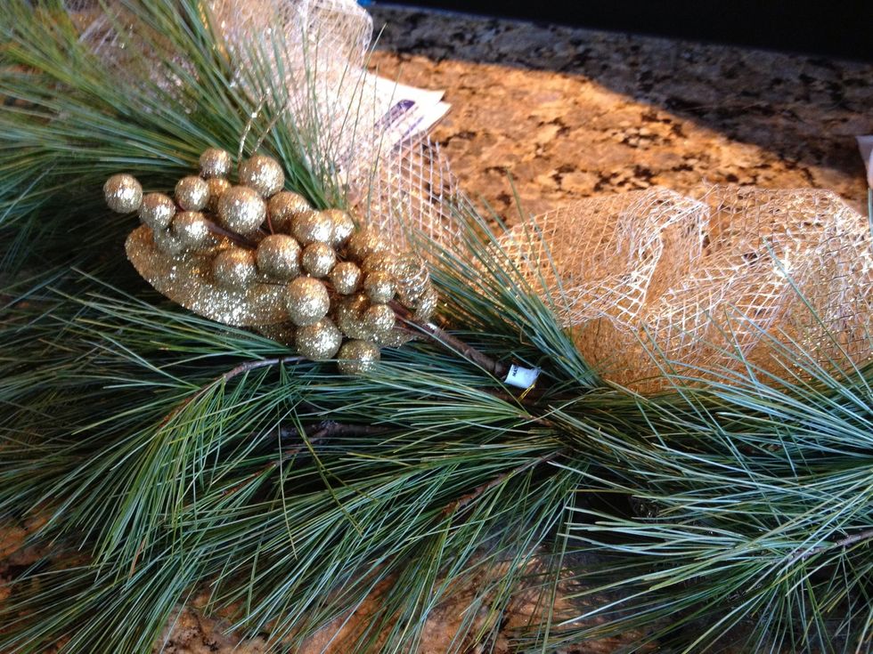 Start decorating. The decors have wire picks so tuck them under the wires that are securing the pine boughs.