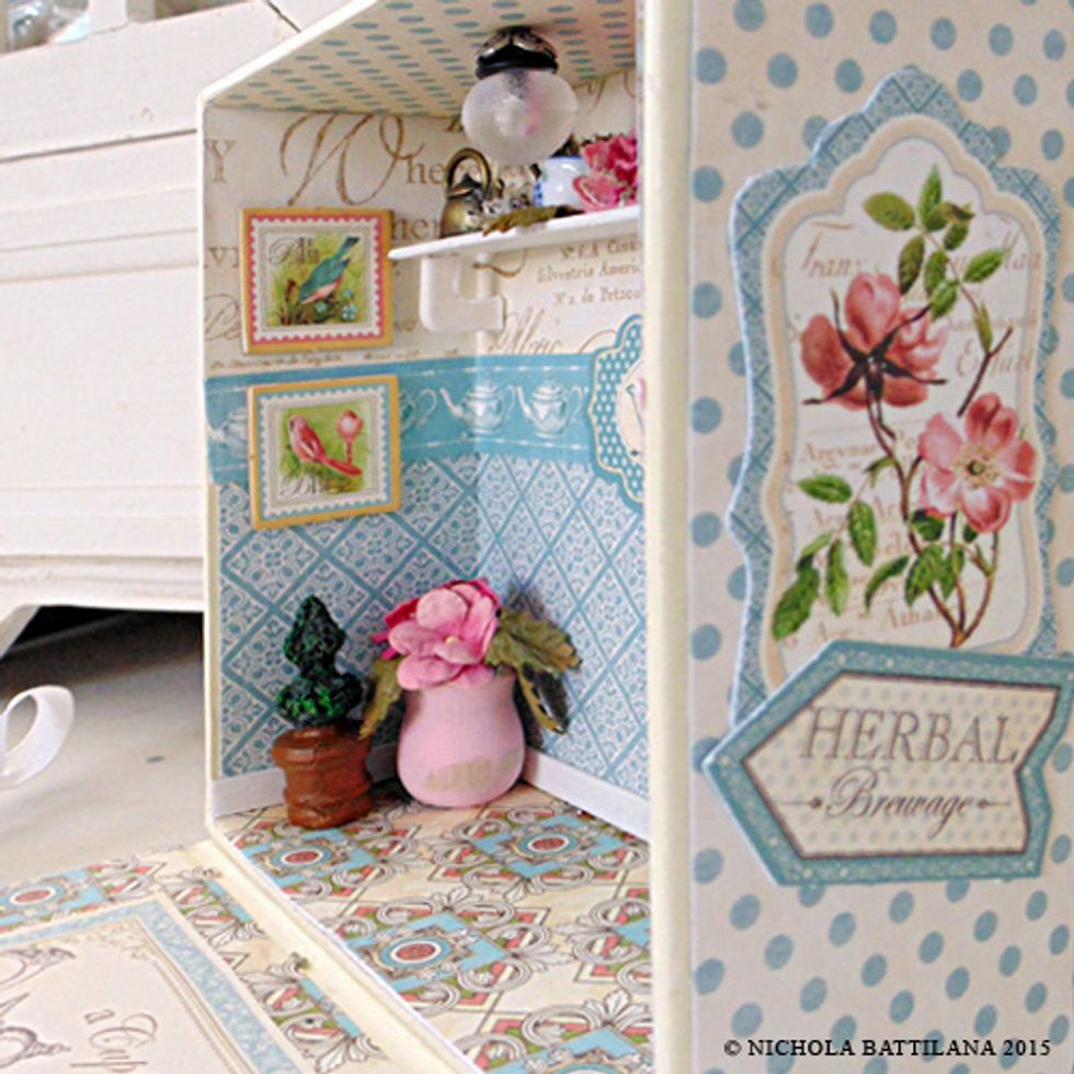 Start dressing the interior! Add little plants and flowers, chipboard tags as pictures for the wall, and teapot charms on your little shelf. You'd be surprised how much will fit in that little space.