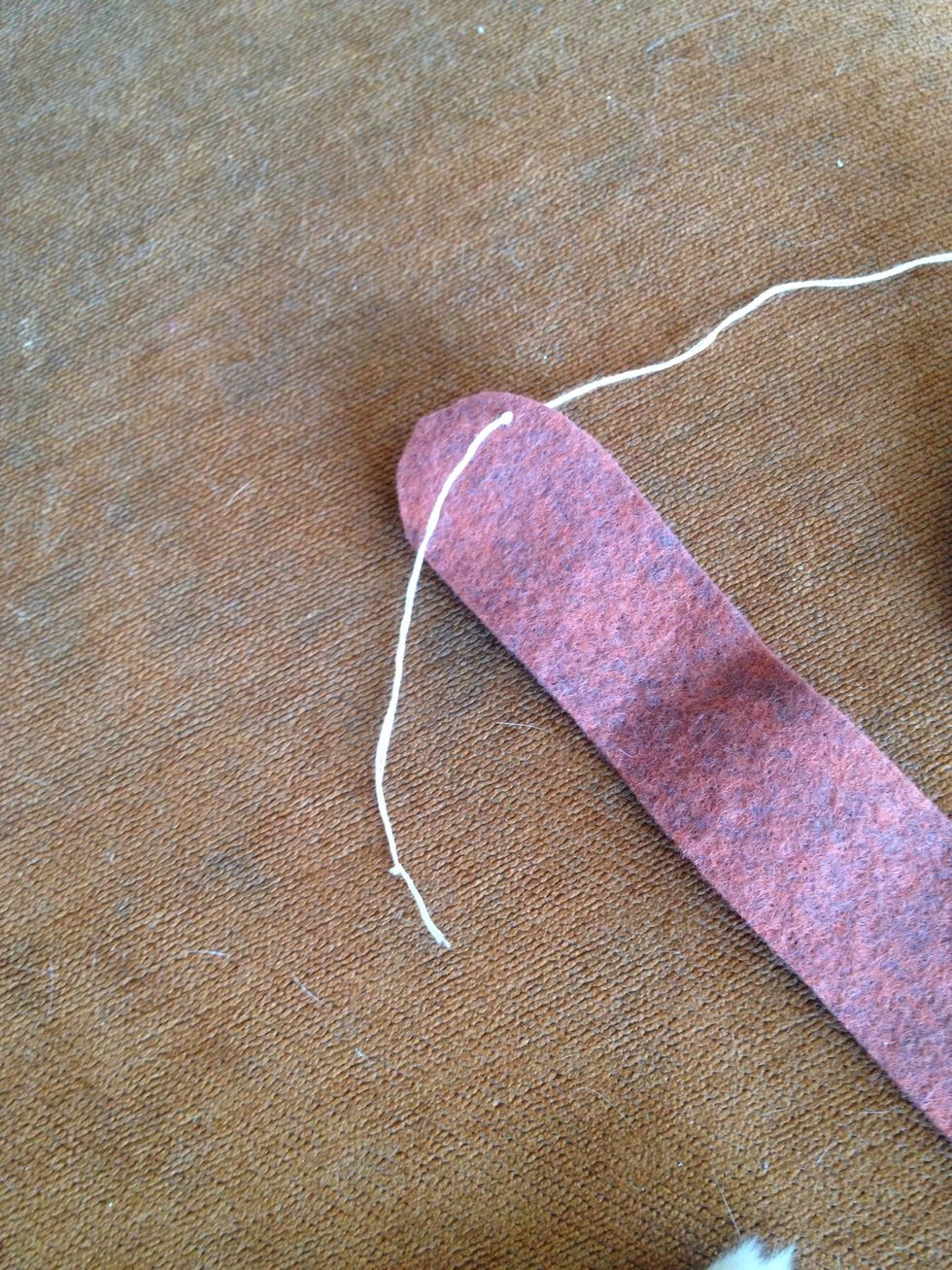 Start embroidering the top of the slipper base with blanket stitch. Make sure to leave a long tail.