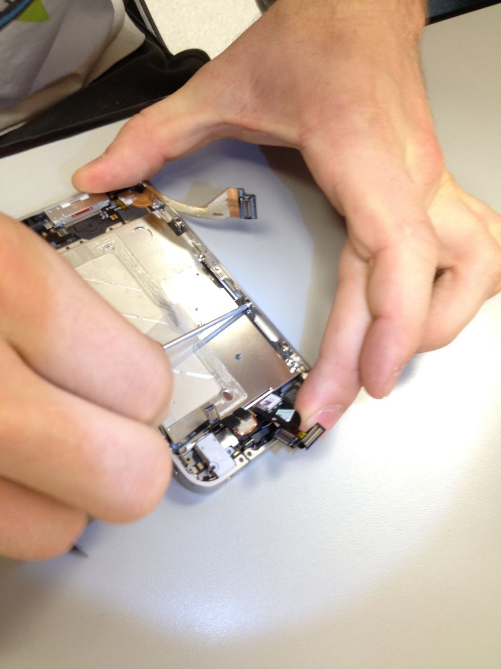 Start feeding the digitizer and LCD cables through. Don't pull too tight. You break it you buy it! Make sure they aren't pinched up before moving forward.