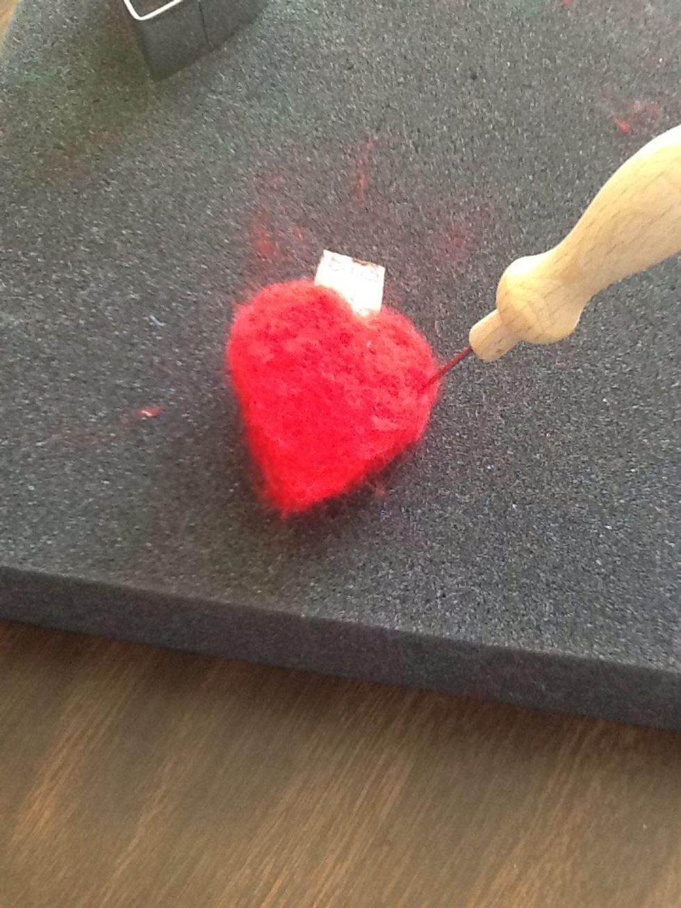 Start felting the sides. Try not to stab the cardboard!