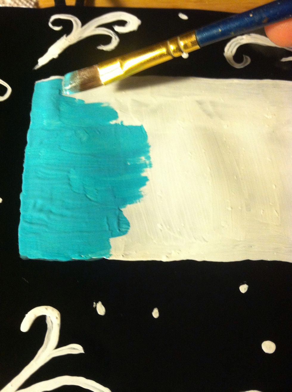 Start filling in the white square with teal paint.
