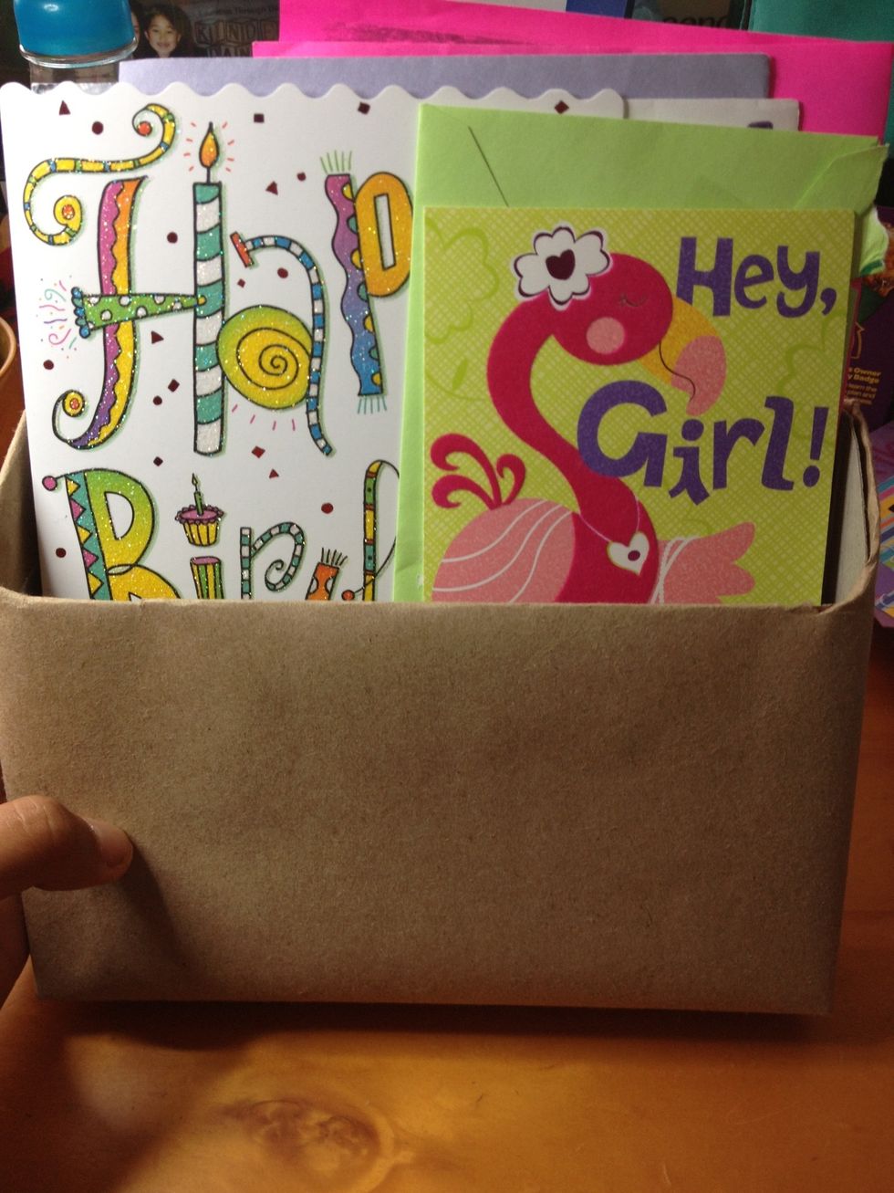 Start filling the box starting with the tallest cards.