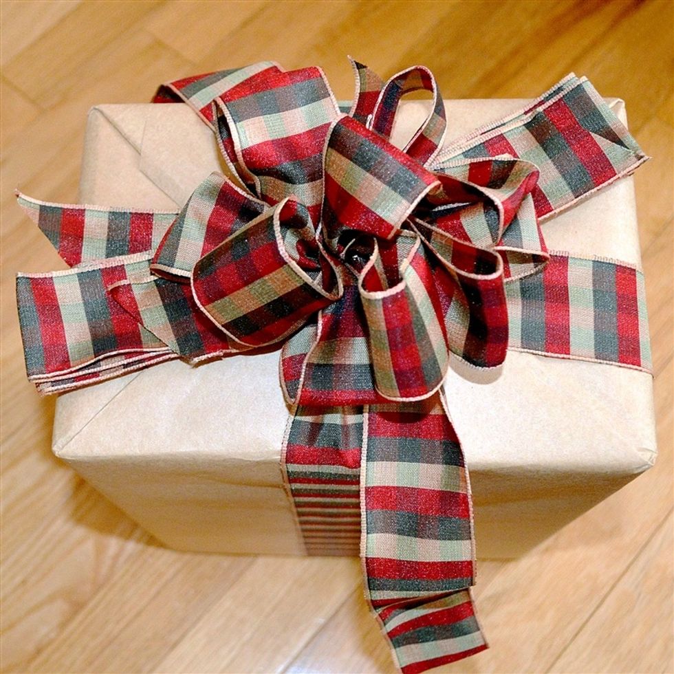 Start fluffing the center loops from the shorter section of accordion folded ribbon.