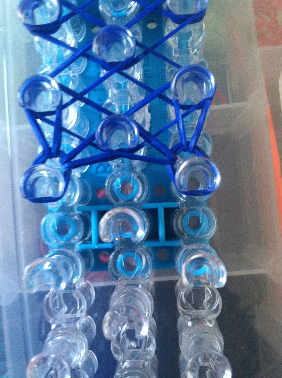 Start looping.. You're going to take the top band loop it on to its self and the vertical band on itself