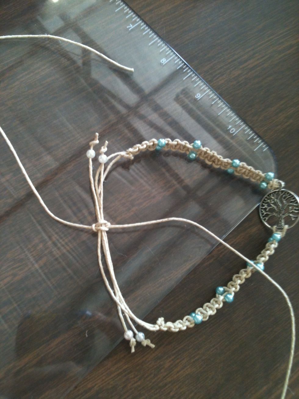 Start making knots on the adjustable strings. Not a lot of knots! Just enough so it could be adjustable. :) also make sure it's loose enough to pull the strings.