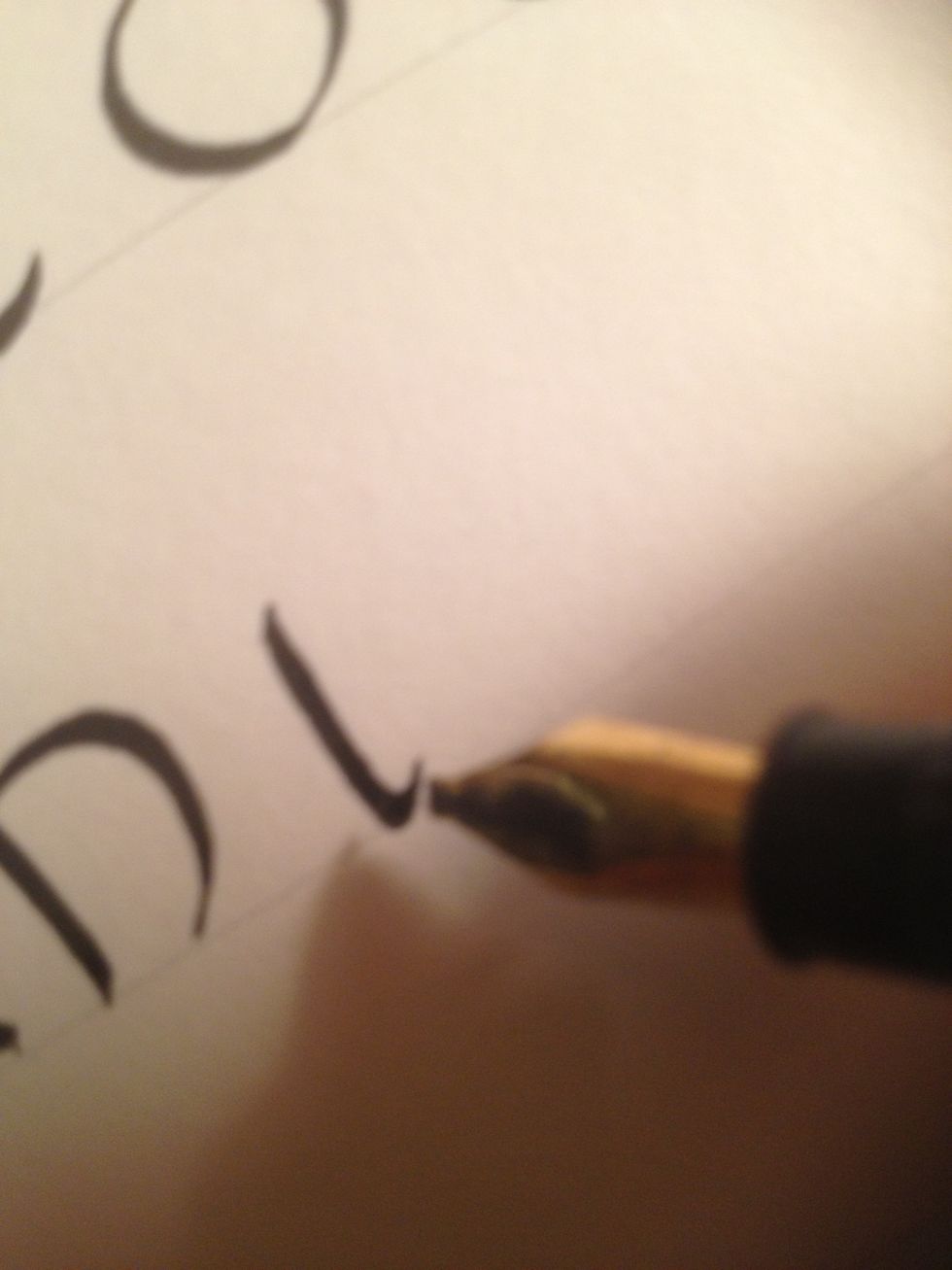 Start N with a slightly curved trunk (no triangle), flourishing at the bottom.