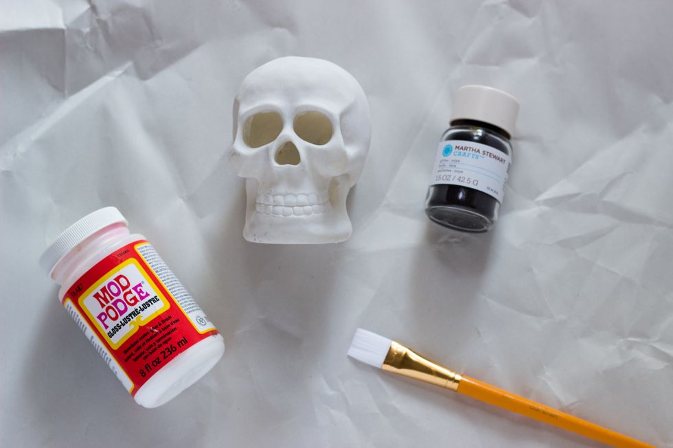 Start off by applying Mod Podge to your skull. Apply the Mod Podge one section at a time. Make sure your skull has an opening at the bottom so that you can put your tealight in it later on.
