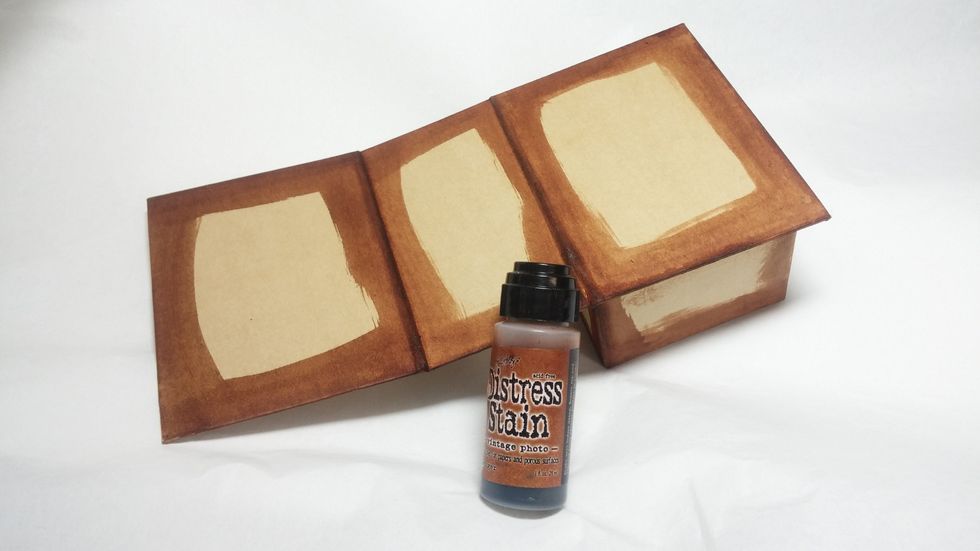 Start off by coloring all the edges of the book box with stain. I also spritzed it with water to activate the fun distress properties of the stain.