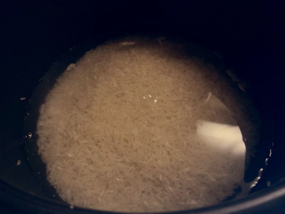 Start off by washing your rice and putting it to cook in the rice cooker. If you don't have a rice cooker, you can cook the rice over the stove but will likely need 3 cups of water total instead.