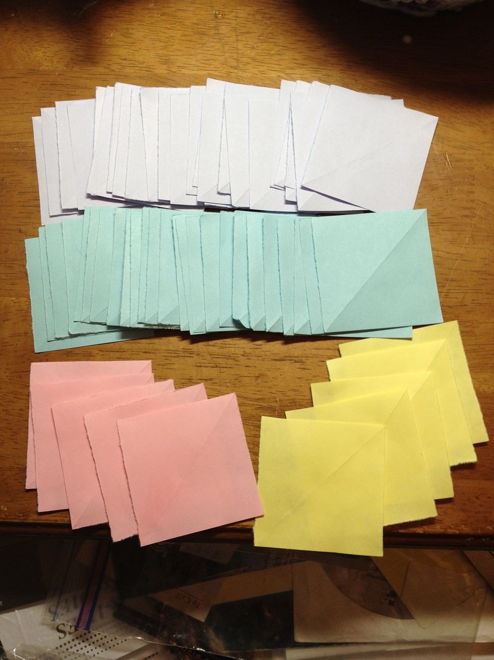 Start off with 60 pieces of paper of equal size. (you may make the pieces bigger or smaller, as you wish). These were cut from 8.5 x 11 pieces of colored paper, folded 4x4.
