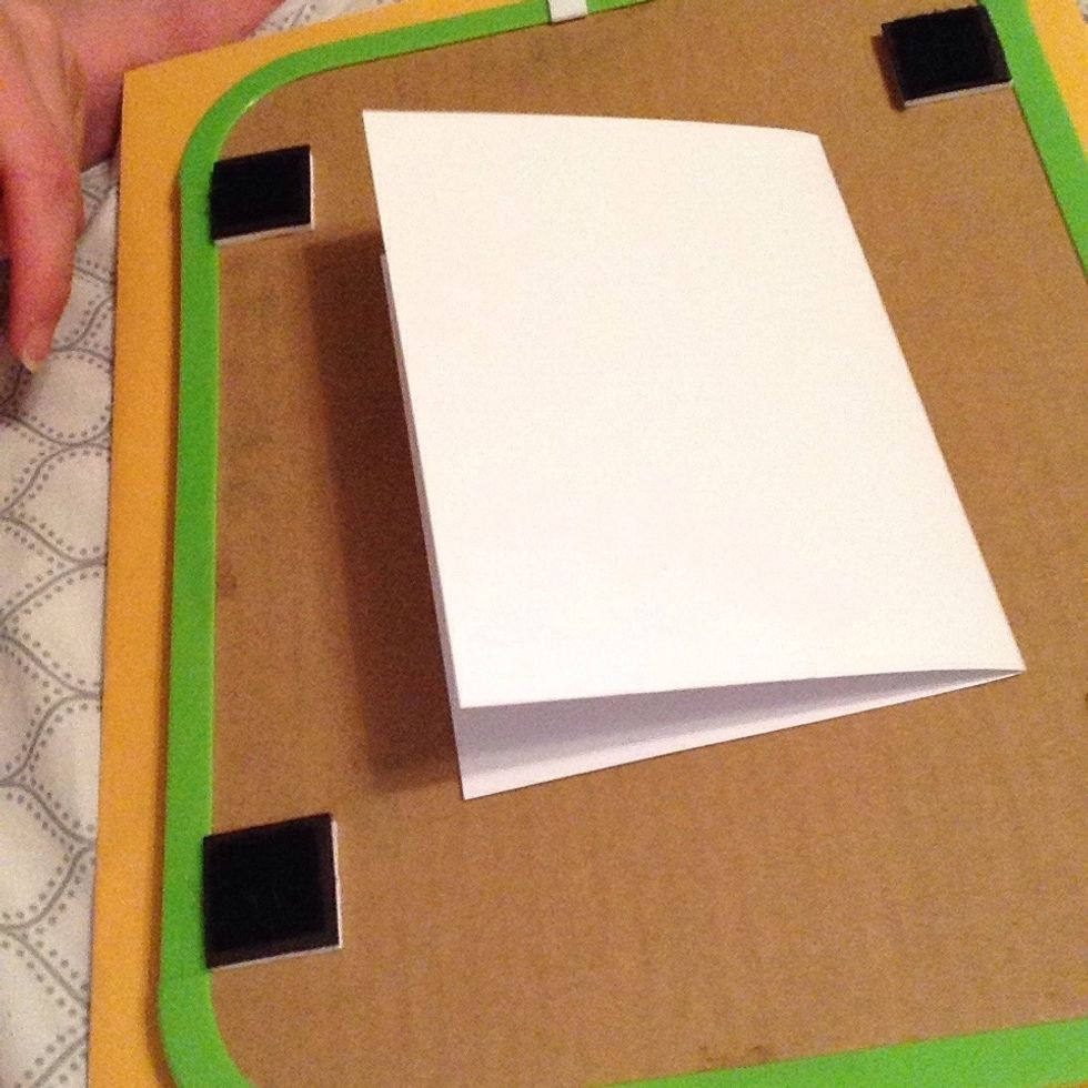 Start off with a sheet of blank white paper, folded in half.