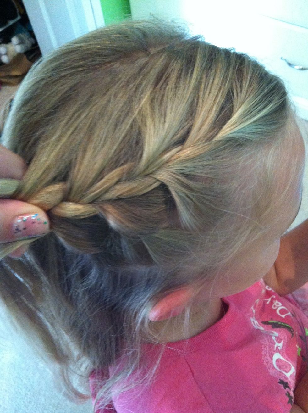 Start on one side of the head and do a regular French braid until you reach the ear.