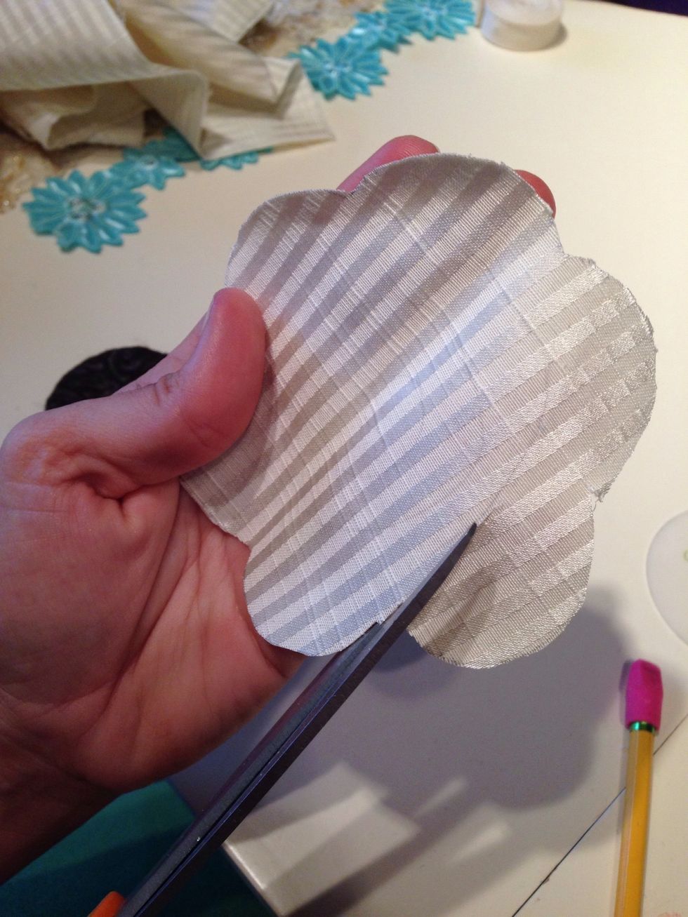 Start on the edge, and cut the center out in a swirl pattern.